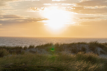 Photograph at the beach and dunes moments before the sun sets in the southwest of the Netherlands. 