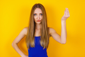 What the hell are you talking about. Shot of frustrated young European woman gesturing with raised hand doing Italian gesture, frowning, being displeased and confused with dumb question.