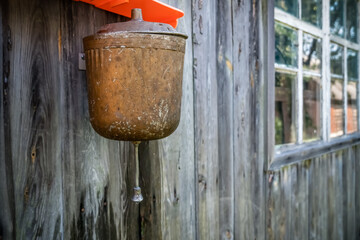 Old street washbasin on a wooden wall in the village on a Sunny day, copy space