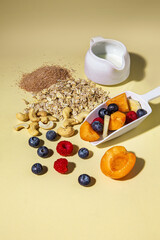 Ingredients of fresh muesli breakfast scattered on the table.