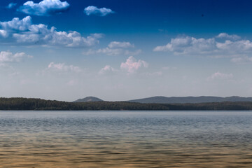 View of the opposite shore of the lake in the afternoon.