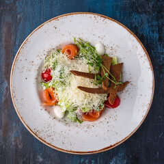 Tasty Caesar salad with salmon. Top view