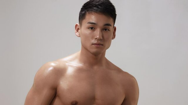 Muscular Asian Man Indoors in th Studio
