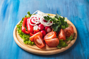 Vegetables plate. Different fresh vegetables on wooden board.  Cold snack