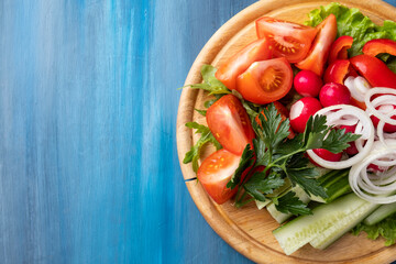 Vegetables plate. Different fresh vegetables on wooden board.  Cold snack. Top view with copy space