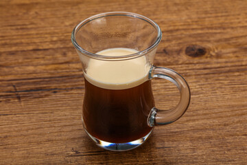 Hot Espresso coffee over wooden table