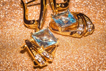 Gold earrings with light blue zirconia