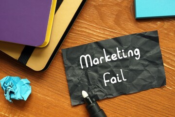 Business concept meaning Marketing Fail with phrase on the piece of paper.