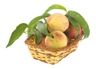Juicy ripe, sweet peaches in a wicker basket isolated on a white background close-up.