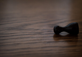 Black pawn laying on the ground