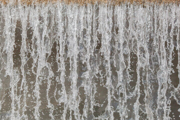 City river waterfall , side view of the falling water flow