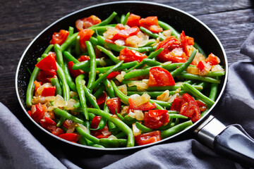 Fried green beans with onions and tomatoes