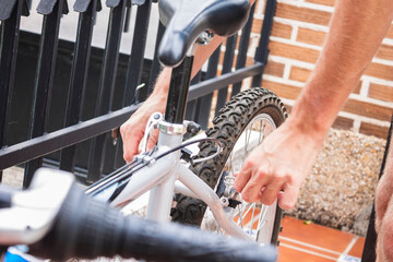Hands Repairing the Back Wheel of a Bicycle