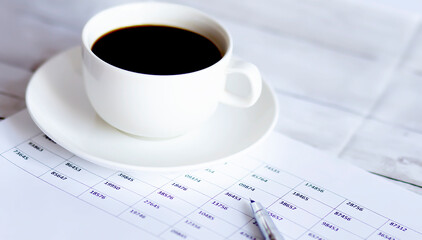 Top view of stuff office desktop and copy space. Analyze data chart show on paper and coffee.