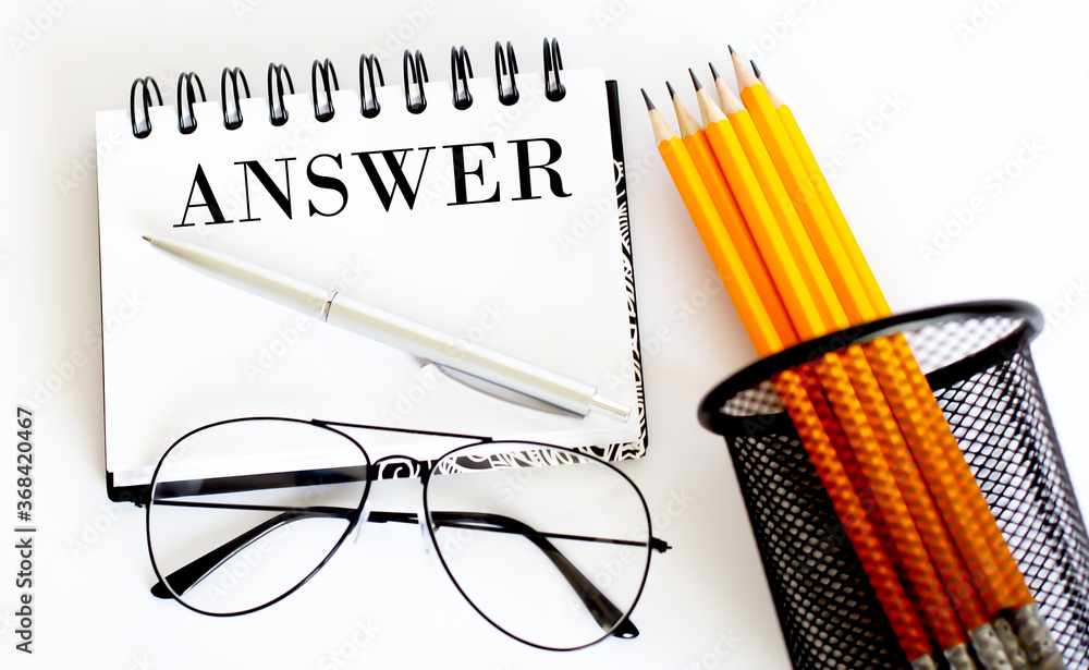 Poster answer concept written on a small notebook with pencil and glasses