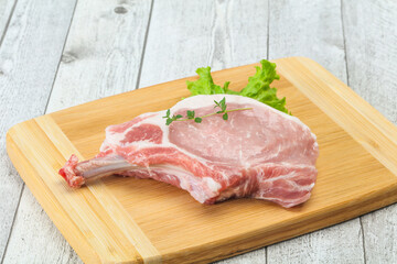 Raw pork bone steak over wooden