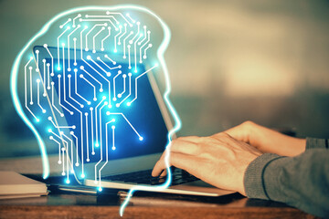 Man typing on keyboard background with brain hologram. Concept of big Data. Double exposure.