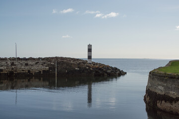 A harbor in Northern Ireland filled with boats, looking out to sea.