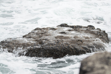 Waves crashing against rocks at the Giant's Causeway, Northern Ireland.