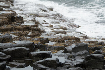 Waves crashing against rocks at the Giant's Causeway, Northern Ireland.