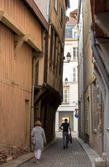 Fototapeta na wymiar Tourists exploring the narrow streets of medieval Troyes old town, Aube, Champagne-Ardenne, France