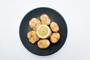 Fried hake with lemon. With white background