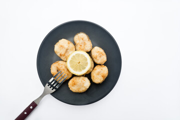 Fried hake with lemon. With white background