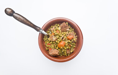 Peas, Pisum sativum, with stewed meat. With white background Asturias, Spain