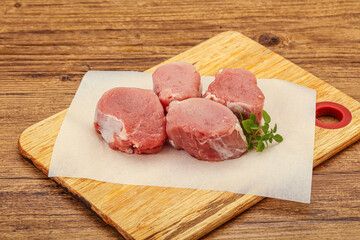 Raw pork medallion served rosemary