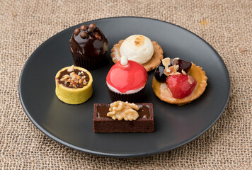 Fruit cake, small. On a black plate. Asturias, Spain
