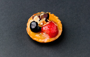 Fruit cake, small. On black background. Asturias, Spain