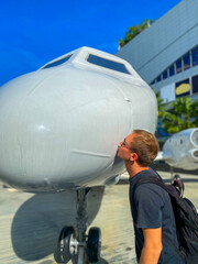 person with airplane. Men kiss the plane