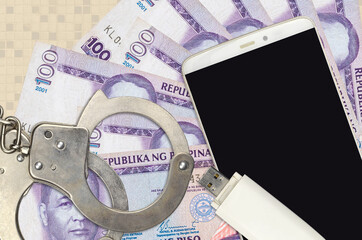 100 Philippine piso bills and smartphone with police handcuffs. Concept of hackers phishing...
