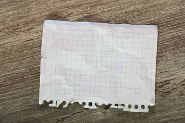 Torn-off sheet of notebook on table