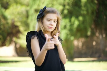 Hey you, bang. Joyful and charismatic good-looking emotive woman with blond curly haircut winking...