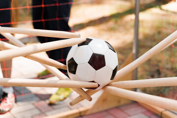 Team building game with soccer ball. People touches ball with sticks. Games for company