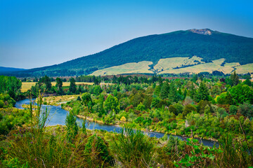 Spectacular landscape of Tongariro river delta down to Lake Taupo with magnificent mountains at the horizon.