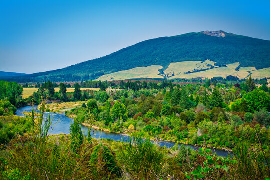 Spectacular landscape of Tongariro river delta down to Lake Taupo with magnificent mountains at the horizon.