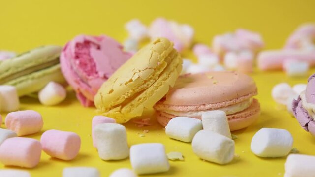 On yellow background macarone fall and crush cookie food dessert destroy sweet color biscuit macaroon french slow motion