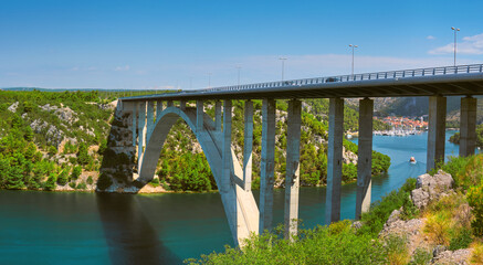 Sibenik Bridge across canyon of the Krka River. Panoramic view towards Scradin town far upstream