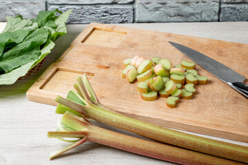 Rhubarb on the table before cooking. Rhubarb on a wooden table. Making of rhubarb