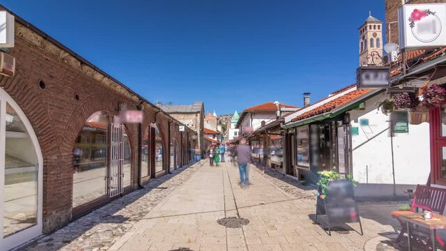 Walk on street in Bascarsija, an oriental bazaar and an old Ottoman historic center of Sarajevo timelapse hyperlapse, Bosnia and Herzegovina. Many shops and caffes around
