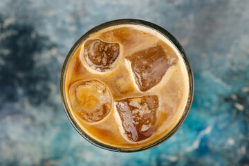 Iced coffee in a glass on the blurry background