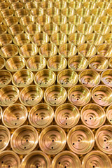 an abstract perspective industrial close-up background of shiny brass metal threaded hexagonal...