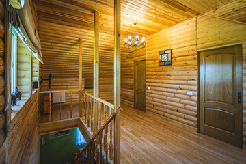 Fototapeta premium Wooden eco interior of private country house. Hall on the second floor.