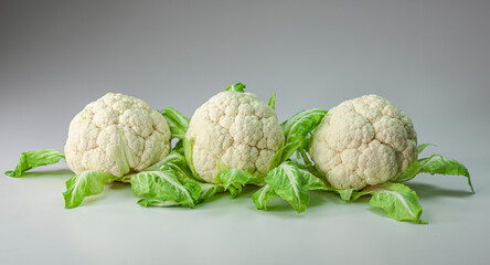 Three fresh cauliflowers isolated on white background