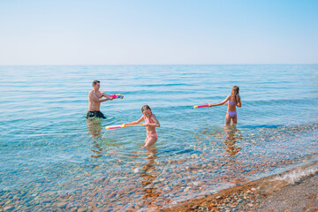 Little girl and happy dad having fun during beach vacation