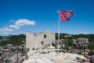 Castle with flag in the historic town of Les Baux de Provence in the south of France