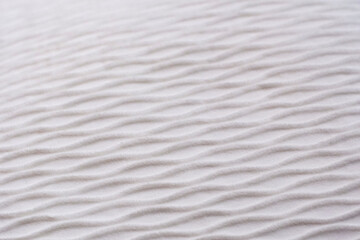Soft blurred white rib waves fabric texture background.