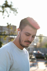 Bluetooth headphones on the ear of a young male person. 